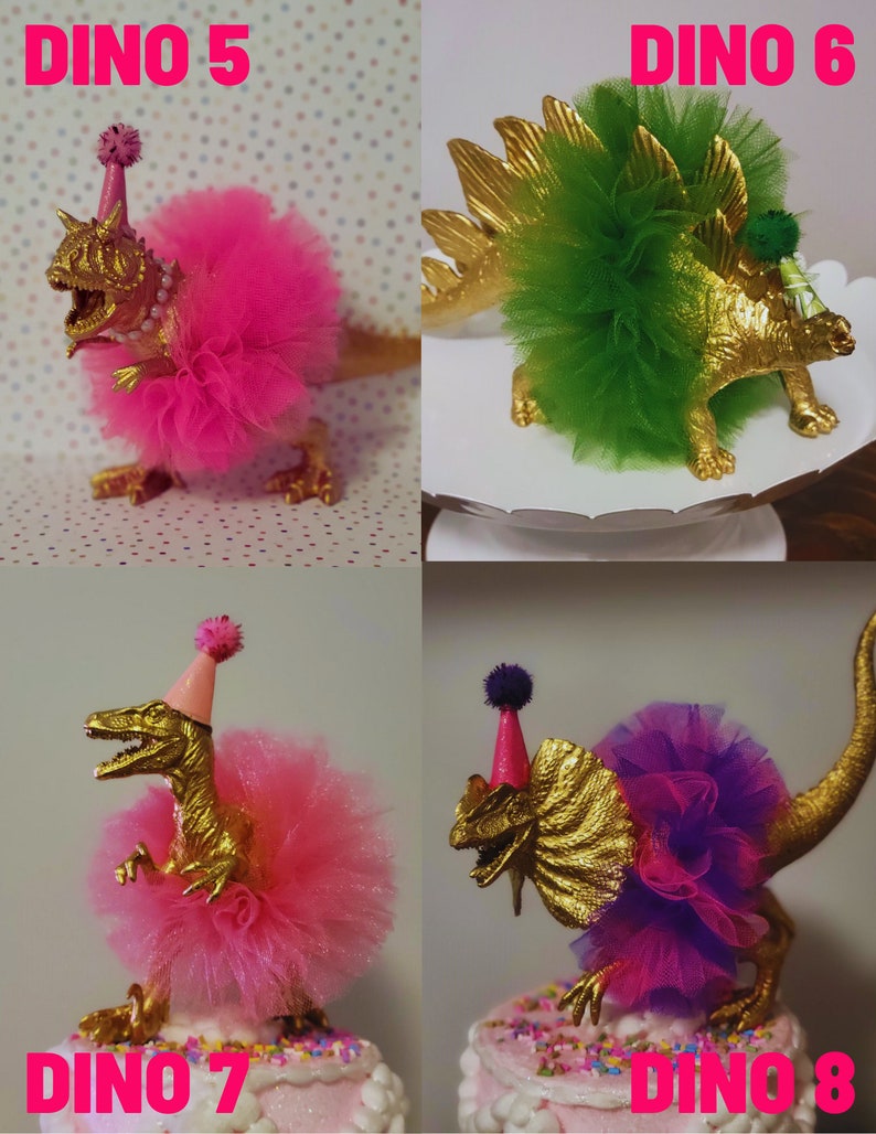 May include: Four gold-painted dinosaur figurines, each adorned with a colorful tutu and party hat. The text "DINO 5", "DINO 6", "DINO 7", and "DINO 8" are displayed in pink. The dinosaurs are cake toppers.