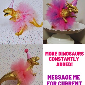 May include: Three gold-colored dinosaur figurines, each adorned with a pink tutu and a party hat. The text "DINO 9", "DINO 10", and "DINO 11" are displayed above each dinosaur. Additional text reads "MORE DINOSAURS CONSTANTLY ADDED!" and "MESSAGE ME FOR CURRENT OFFERINGS!"