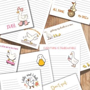 May include: A collection of lined notepads with various cartoon goose illustrations and phrases. The notepads feature phrases like "SLAY," "ALL PANIC, NO DISCO," and "Don't quit." The illustrations depict geese in various poses and activities.