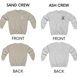 May include: Two crewneck sweatshirts, one in sand and one in ash grey, with a small graphic of a ghost on the front. The text "Cultured Spooky" is printed below the ghost. The sweatshirts are shown from the front and back.
