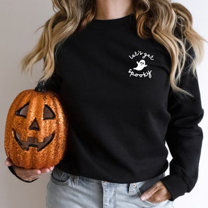 May include: Black sweatshirt with a white ghost graphic and the text "Let's get spooky".