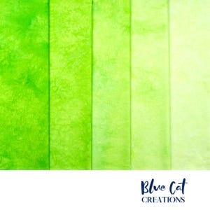 May include: A fabric swatch featuring a gradient of green hues, ranging from vibrant lime to pale chartreuse. The fabric has a textured, mottled appearance, with visible patterns. The Blue Cat Creations logo is at the bottom.