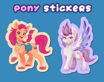 May include: Two colourful pony stickers on a blue background. One pony is orange with a pink mane and tail, wearing a blue bag. The other is white with a pink, blue, and purple mane, wings, and tail. The text "Pony stickers" is at the top.