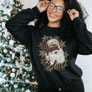 Believe black santa sweater deals