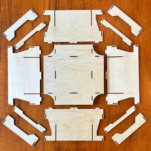 May include: A set of nine unfinished wooden pieces for building a small wooden box. The pieces are cut and ready to be assembled.