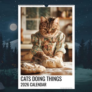 May include: A 2026 calendar with a cat in an apron and floral sleeves, kneading dough on a wooden surface. The calendar reads "CATS DOING THINGS" and includes an Etsy shop URL. The background depicts a kitchen scene.