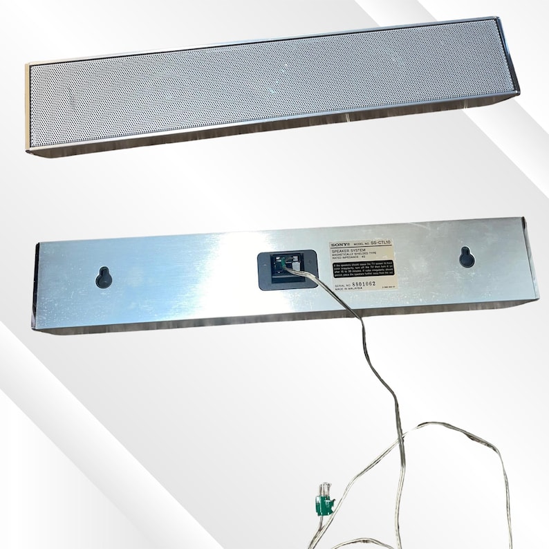 May include: A silver Sony SS-CTLM speaker system. The top of the speaker has a perforated metal grill. The bottom of the speaker has a label and a port for the power cord. The speaker is rectangular and has a modern design.