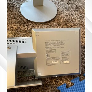 May include: Silver Sony HCD-LF10 Super Audio CD/DVD player. The device is rectangular with a series of small holes on the side. The back of the device has a certification label and the text "SUPER AUDIO CD/DVD PLAYER".