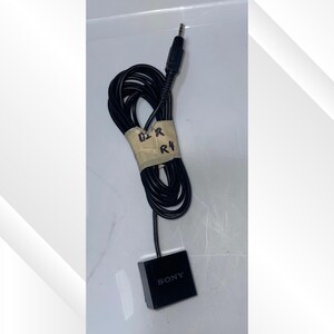 May include: A black Sony audio cable with a 3.5mm jack and a small black box. The cable is coiled and secured with tape labeled "D2 R R4".