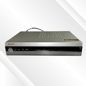 May include: Silver Pioneer media receiver PDP-R05U. The device has a black front panel with a power button and other control buttons. The top of the device is silver with ventilation holes. The device has HDMI and other ports.