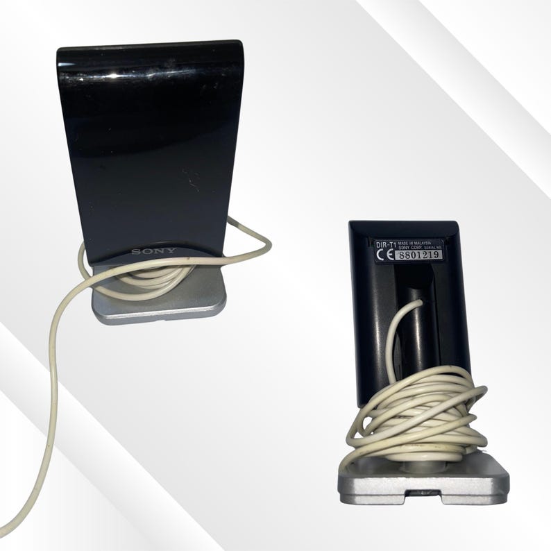 May include: Two black Sony DIR-T1 speakers with silver bases and white cords. The speakers have a glossy finish and a rectangular shape. One speaker shows the Sony logo, and the other shows the model number and serial number.