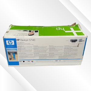 May include: A cardboard box for an HP Deskjet 5740 color inkjet printer. The box is white with green and blue accents, and features the HP logo. Text on the box includes the printer model and product information.