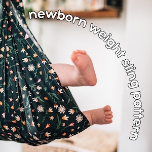 May include: A dark green newborn sling with a floral pattern, holding a baby's feet. The sling has a design of white, orange, and pink flowers. Text on the image reads "newborn weight sling pattern".