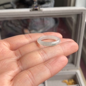 May include: A light green jadeite ring with a smooth, polished finish.