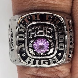May include: Silver class ring with a purple stone, the words "North Cal High" and "ABC" are engraved on the ring.