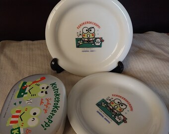 Four: Three 90s Kerokerokeroppi Sanrio Plates + One Tin; New