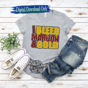 May include: A gray t-shirt with the text "I BLEED MAROON & GOLD" in maroon and gold lettering. The shirt is paired with blue jeans and white sneakers. The words "Digital Download Only" are above the shirt.