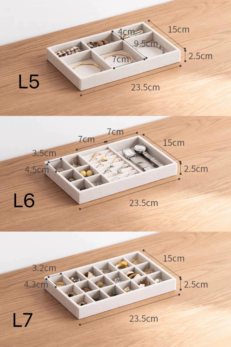 May include: Three beige velvet jewelry organizer trays labeled L5, L6, and L7. Each tray measures 23.5cm by 15cm by 2.5cm. L5 has six compartments, L6 has twelve, and L7 has twenty-four. The trays contain various rings, watches, and earrings.