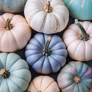 May include: Overhead view of pastel pumpkins in shades of blue, pink, and white. The pumpkins have textured surfaces and green and brown stems. Some have gold or orange accents. A seasonal autumn theme.
