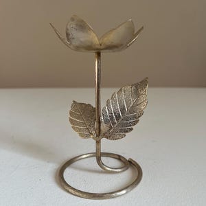 1970s brass “flaming tulip” candle by Avon
