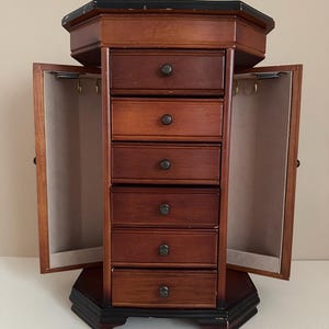 1960s cherry colored wood armoire style jewelry box with removable drawers