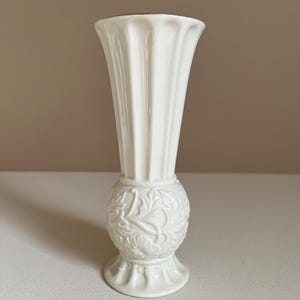 1980s cream colored trumpet vase with 24k gold rim and raised floral detail