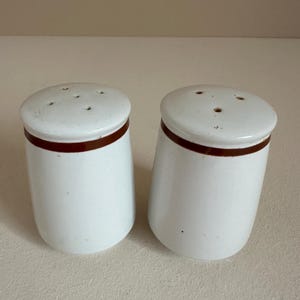 1960s cream colored salt and pepper shakers with maroon stripes, sold as a pair