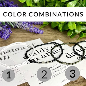 May include: Three different color combinations of beaded bracelets with the words "mama of an angel", "daddy of an angel", and "daddy of a" on cards behind them. The bracelets are white, black, and green.