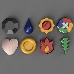 May include: An assortment of eight colorful, geometric-shaped objects. The shapes include a black octagon, a blue teardrop, a red and yellow starburst, a multi-colored flower, a pink heart, a gold ring, a red flame, and a green leaf.