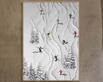May include: A white canvas painting depicting a snowy mountain scene with skiers and snowboarders in colorful clothing. The painting has a textured, 3D effect.