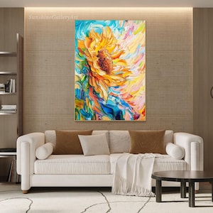 May include: Abstract painting of a sunflower with vibrant colors, including yellow, blue, and pink. The sunflower is painted in a stylized, impressionistic style.
