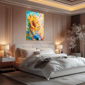 May include: A painting of a large yellow sunflower with blue, green, and pink accents. The painting is framed and hanging on a wall in a bedroom with a white bed and a small white nightstand.