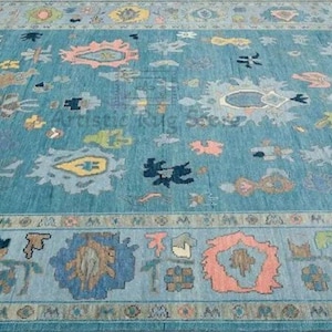 a large blue rug with many different designs on it