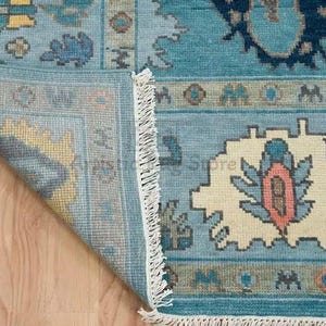 a close up of a rug on a wooden floor
