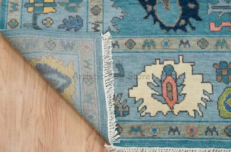 a close up of a rug on a wooden floor