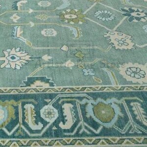 a blue and green rug with a pattern on it
