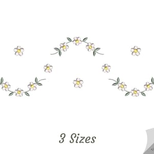 May include: Three embroidery designs featuring white daisy flowers with yellow centres and green leaves. The designs are arranged in a symmetrical pattern with two curved rows of flowers and a single row of flowers in the centre.