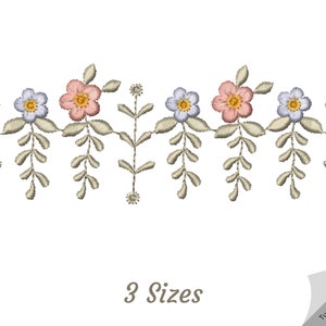 May include: A delicate floral embroidery design featuring pink and blue flowers with green stems and leaves. The design is repeated horizontally and is available in three sizes.