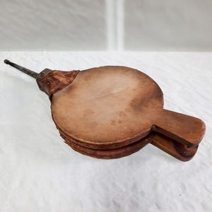 Fole de lareira antigo. Iniciador de fogo primitivo. Fole de madeira antigo