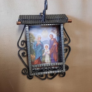 Small vintage icon. Antique metal frame with an icon. Holy family. Religion.