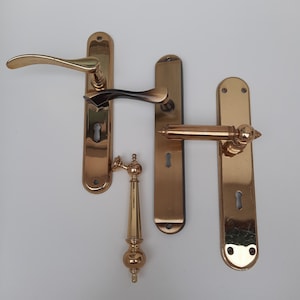 Brass door handles. Classic door handles in different colors and sizes. Door furniture.
