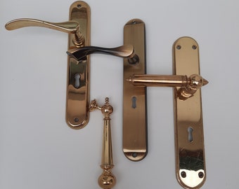 Brass door handles. Classic door handles in different colors and sizes. Door furniture.