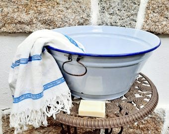 Large vintage enamel basin. Blue metal enamel sink with hanging handle. Washing bowl.