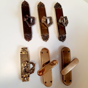 Brass window handles. Decorative handles for windows of different colors and sizes. Window fittings.