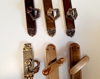 Brass window handles. Decorative handles for windows of different colors and sizes. Window fittings.