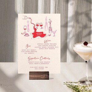 Peut inclure: Un menu de boissons illustré en rose et rouge avec un verre à vin, une bouteille et une tasse de café. Le menu propose du vin, de la bière et des cocktails signature. Le texte indique "Drinks Menu", "Wine", "Chateau Grand Traverse", "Late Harvest Riesling", "Chateau Grand Traverse 2016", "Gamay Noir Reserve", "Beer", "Gipsy Hill Bandit", "Five Shore Brewing", "IPA, Moretti", "Signature Cocktails", "Brissi's Plum Sake Negroni", "Spicy Tommy's Margarita", "Plus Soft Drinks, Tea and Coffee".