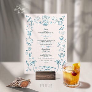 May include: A beach-themed menu with teal illustrations and text, including beer, wine, and signature cocktails. A cocktail with a cherry and orange slice sits next to the menu. A seashell and wooden stand are also present.