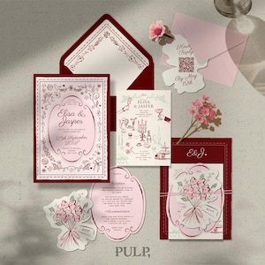 May include: A collection of wedding stationery in shades of burgundy and pink. The set includes invitations, RSVP cards, and decorative stickers, all featuring floral and botanical illustrations. The invitation cards display the names "Elisa & Jasper" and the date "29th September".