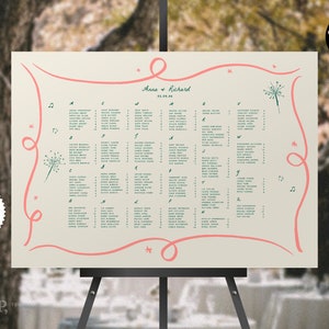 Puede incluir: Un plano de asientos de boda imprimible con un fondo beige claro. El plano de asientos presenta un diseño de cinta rosa con un gráfico de diente de león y el texto "Anna + Richard" y "05.09.14".