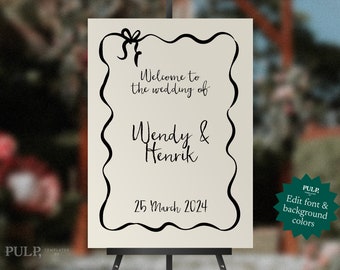 May include: A white wedding sign with a black border and a handwritten message that says "Welcome to the wedding of Wendy & Henrik 25 March 2024".